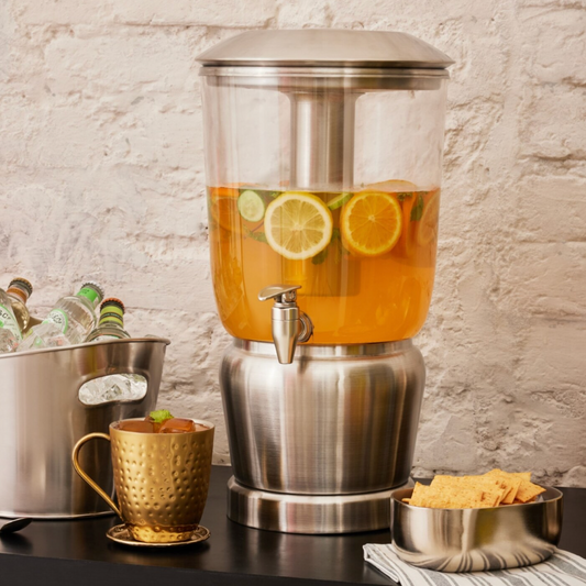 Moonlit Silver Luminique dispenser in Stainless Steel shine filled with infused liquid with fresh citrus fruits along with side condiments