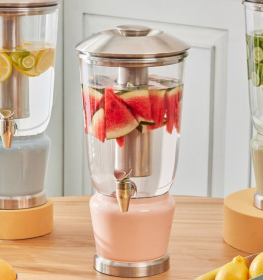 Blush Rose Luminique dispenser in blush pink filled with water infused with fresh red watermelons