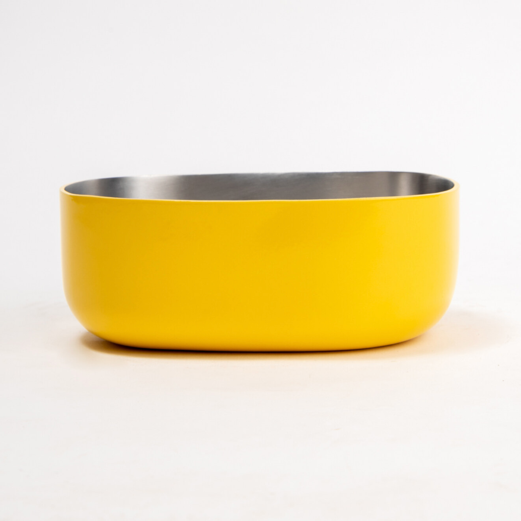 Side view of a stainless steel Celestique Bowl in citrus burst yellow with silver interior