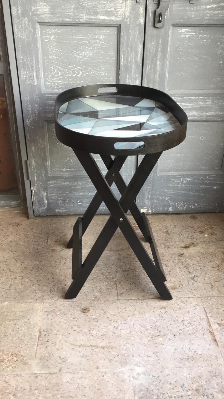 Motif in grey set against black wood finish Facets Black Oval Butler Table - Artychoke